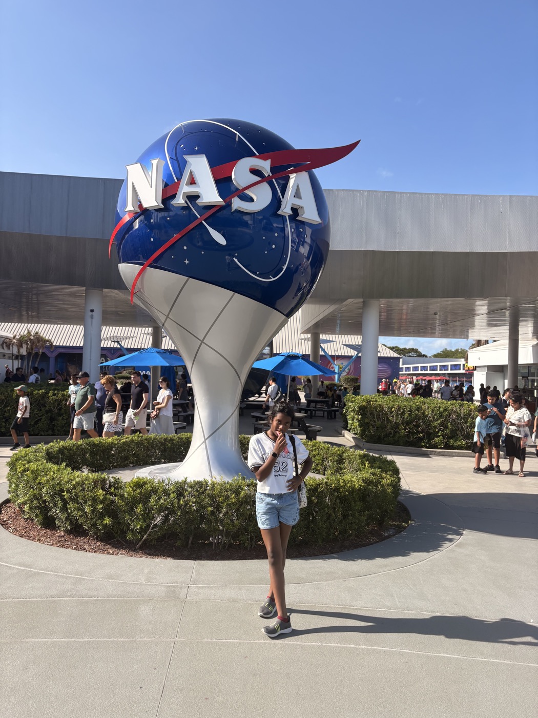 Tanya in front of the NASA meatball logo globe sculpture