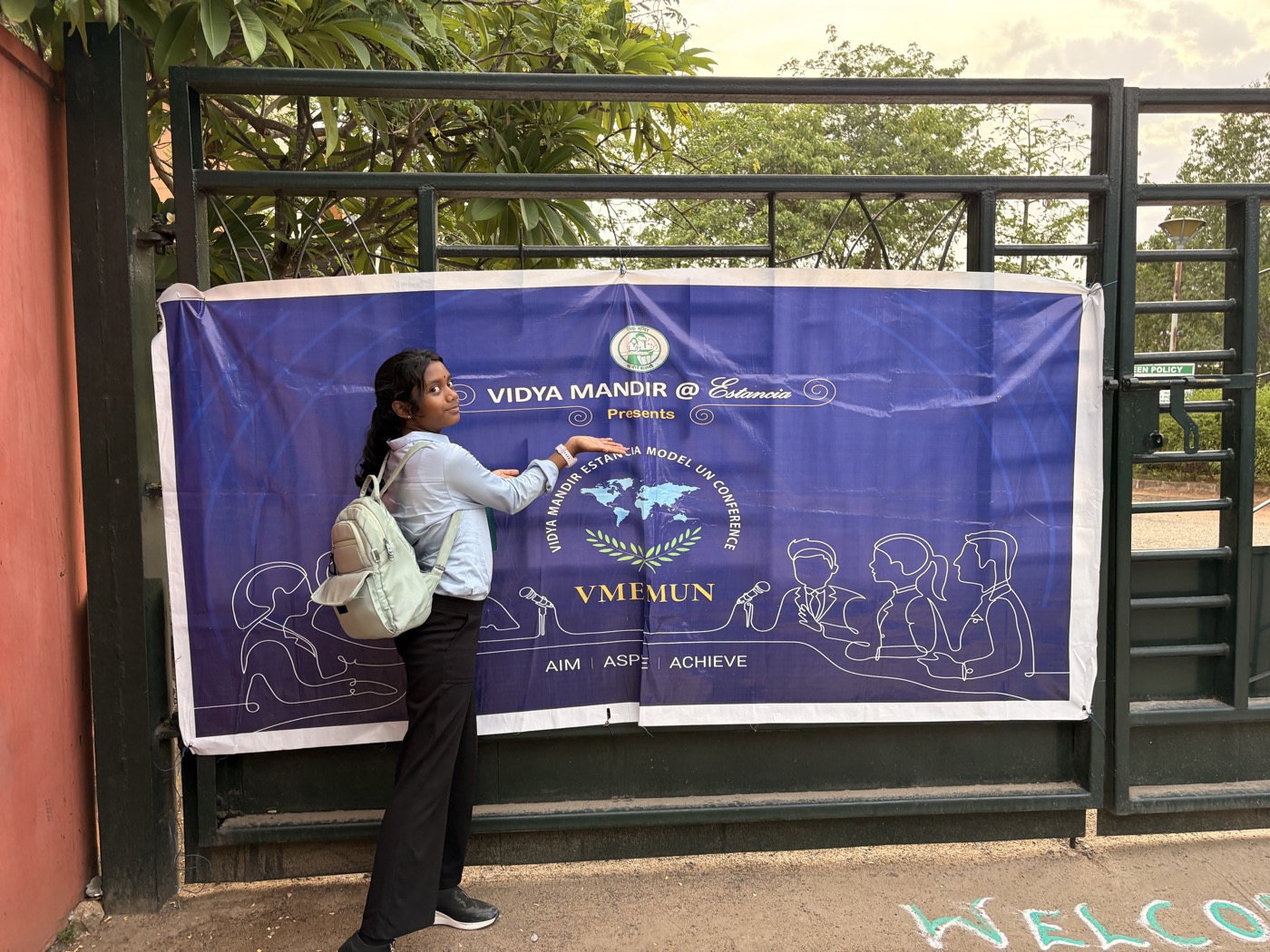 Tanya at the school gate, heading in with her MUN banner